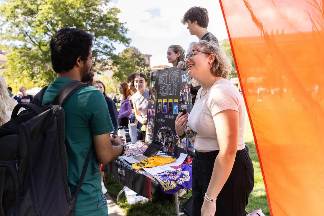 Students talking at a table.